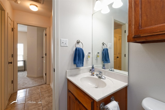 390 Sugarberry Ave, Abilene, TX 79602 - half bathroom with vanity, toilet, and tile patterned flooring
