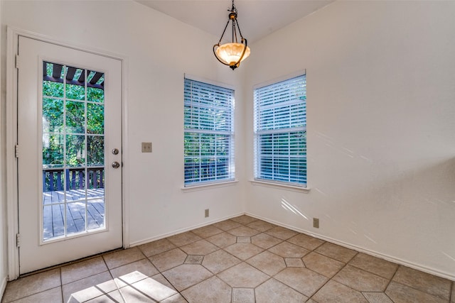 unfurnished dining area featuring light tile patterned flooring