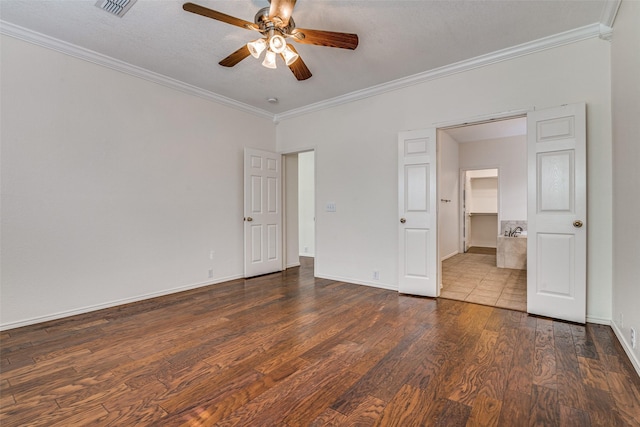unfurnished bedroom with ornamental molding, dark wood-type flooring, baseboards, and a ceiling fan