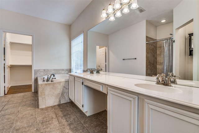 full bathroom with a bath, tiled shower, and double vanity