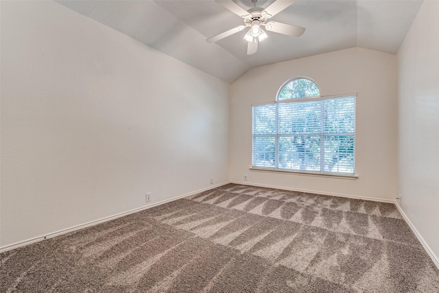 carpeted spare room featuring lofted ceiling, ceiling fan, and baseboards