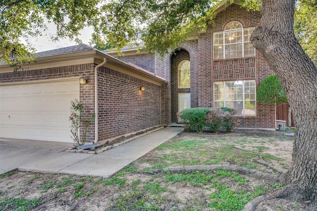 view of front facade featuring brick siding and an attached garage