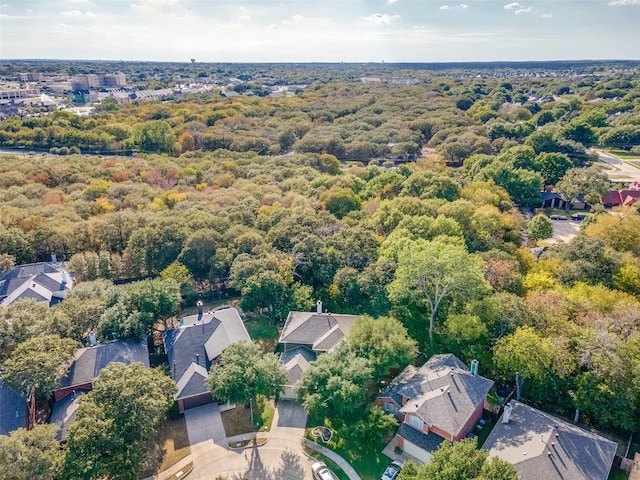 aerial overview of property's location featuring nearby suburban area and a heavily wooded area