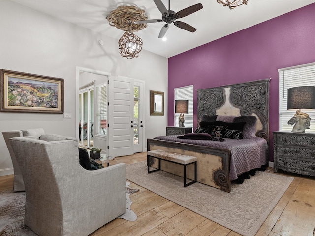 bedroom with high vaulted ceiling and wood-type flooring