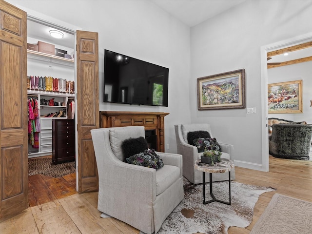 sitting room featuring hardwood / wood-style floors and baseboards