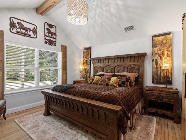 bedroom with wood finished floors, a chandelier, and baseboards
