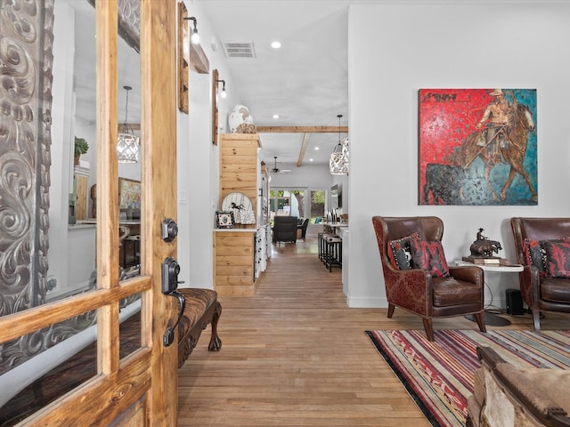 foyer entrance with light wood-style flooring, recessed lighting, beam ceiling, and baseboards