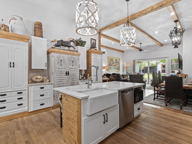 kitchen with stainless steel dishwasher, a sink, ceiling fan, recessed lighting, and decorative backsplash