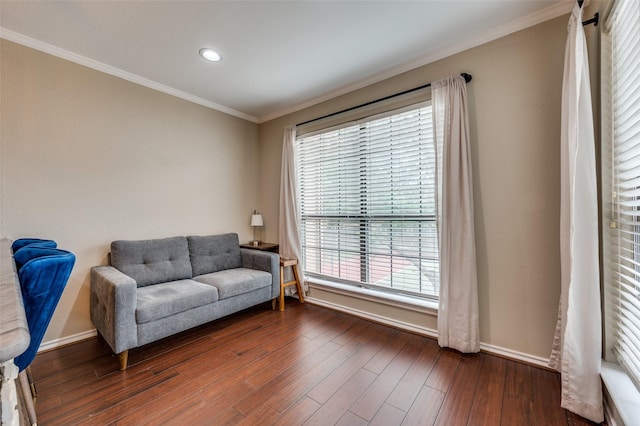 sitting room with dark wood finished floors, ornamental molding, baseboards, and recessed lighting