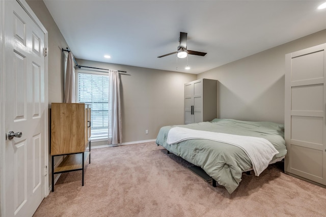 bedroom with light carpet, recessed lighting, baseboards, and a ceiling fan