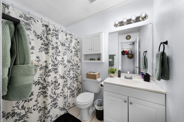 400 Houston St, Sulphur Springs, TX 75482 - bathroom featuring a textured ceiling, tile patterned floors, ornamental molding, vanity, and toilet