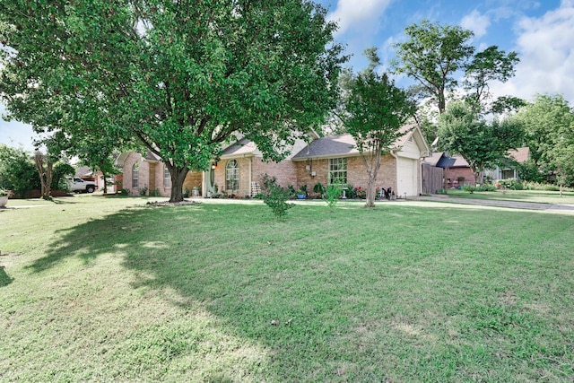 400 Houston St, Sulphur Springs, TX 75482 - view of front of property featuring a garage, brick siding, a front lawn, and driveway