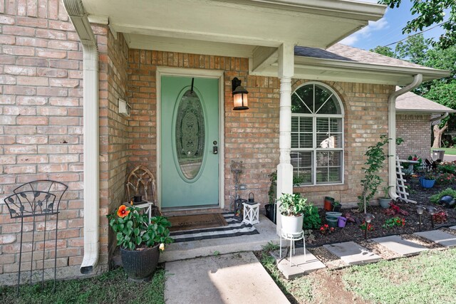 400 Houston St, Sulphur Springs, TX 75482 - view of exterior entry featuring brick siding and a shingled roof