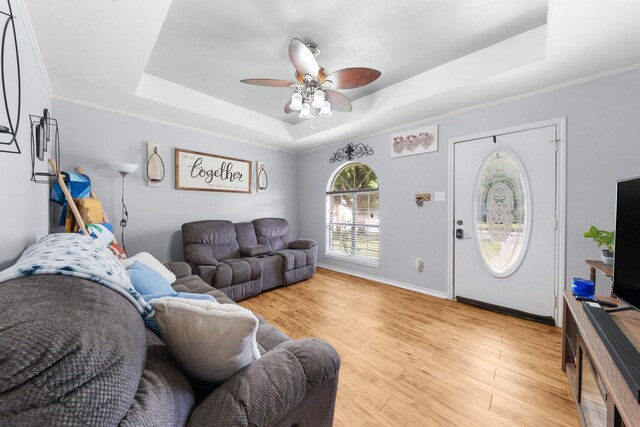 400 Houston St, Sulphur Springs, TX 75482 - living room featuring a tray ceiling, ceiling fan, light wood-style flooring, and baseboards