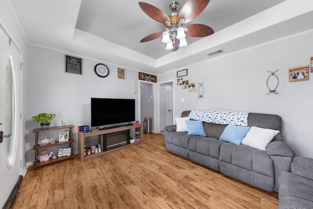 400 Houston St, Sulphur Springs, TX 75482 - living area featuring a raised ceiling, a ceiling fan, wood finished floors, ornamental molding, and baseboards