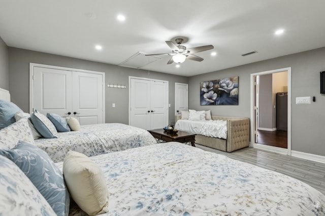 400 Crooked Ln, Mesquite, TX 75149 - bedroom with attic access, two closets, baseboards, wood finished floors, and recessed lighting