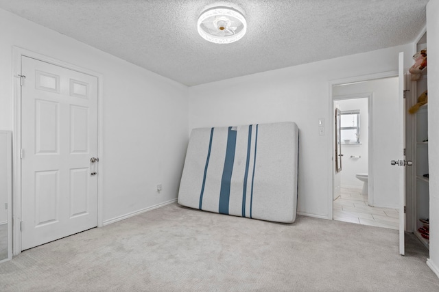 1426 Northridge Dr, Carrollton, TX 75006 - unfurnished bedroom featuring carpet flooring, a textured ceiling, and baseboards