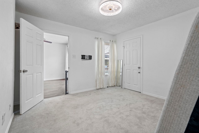 1426 Northridge Dr, Carrollton, TX 75006 - unfurnished bedroom with a textured ceiling, carpet flooring, and baseboards