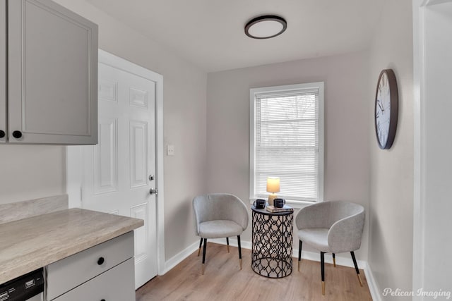 sitting room with light wood-style flooring and baseboards
