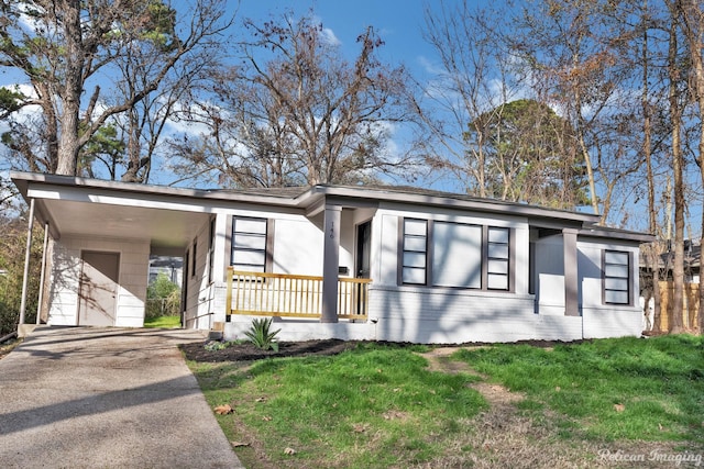 mid-century modern home with a front yard, driveway, and an attached carport