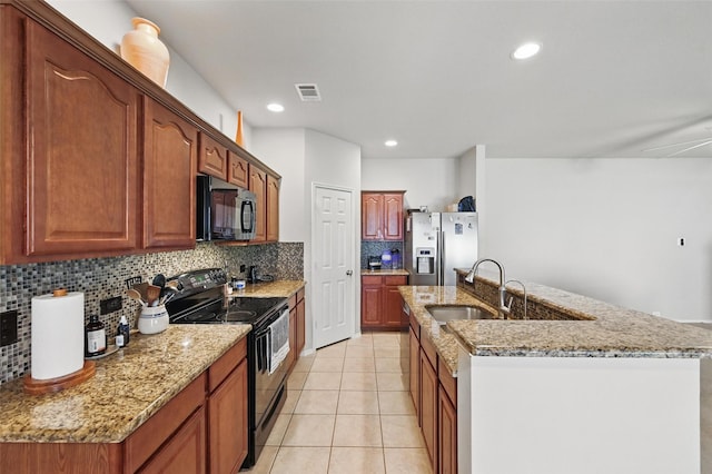 1418 Ravenwood Dr, Mansfield, TX 76063 - kitchen with black electric range oven, stainless steel fridge, backsplash, a sink, and light stone counters