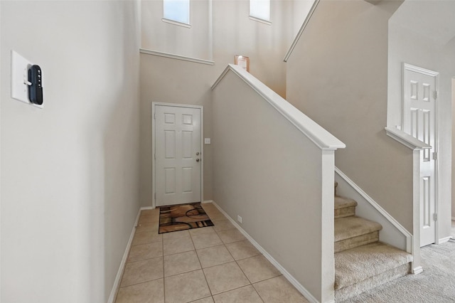 1418 Ravenwood Dr, Mansfield, TX 76063 - entrance foyer with stairs, baseboards, a towering ceiling, and light tile patterned flooring