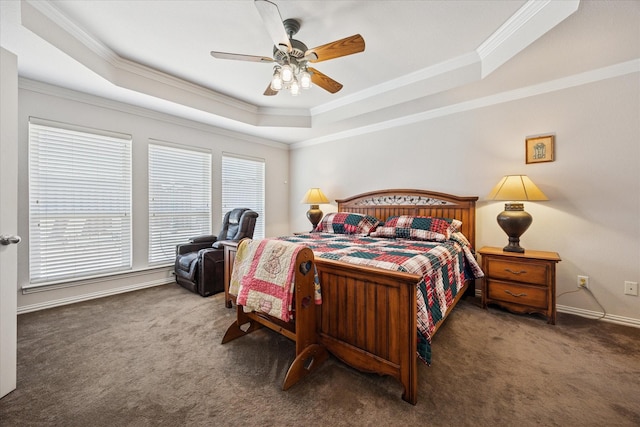 bedroom with a raised ceiling, carpet, crown molding, baseboards, and ceiling fan