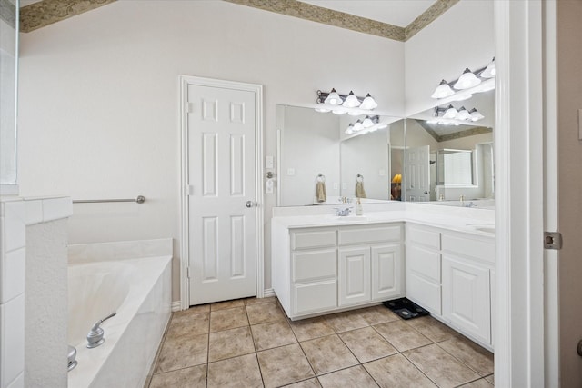 bathroom featuring a garden tub, double vanity, and tile patterned floors