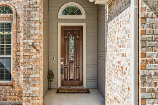 property entrance with brick siding