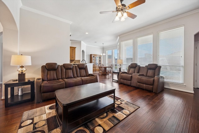 living room featuring ceiling fan, dark wood-style flooring, arched walkways, crown molding, and recessed lighting