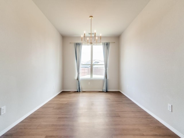 3305 Brentwood Cv, Forney, TX 75126 - empty room with a chandelier, wood finished floors, and baseboards