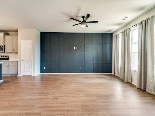 3305 Brentwood Cv, Forney, TX 75126 - unfurnished living room with a ceiling fan, light wood-style flooring, and baseboards