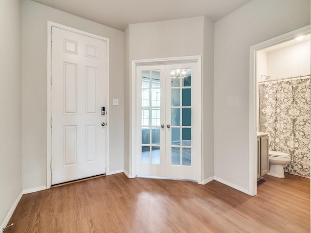3305 Brentwood Cv, Forney, TX 75126 - foyer entrance with french doors, wood finished floors, and baseboards