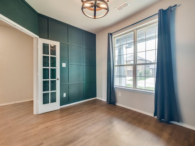 3305 Brentwood Cv, Forney, TX 75126 - spare room with a chandelier, light wood-type flooring, and baseboards