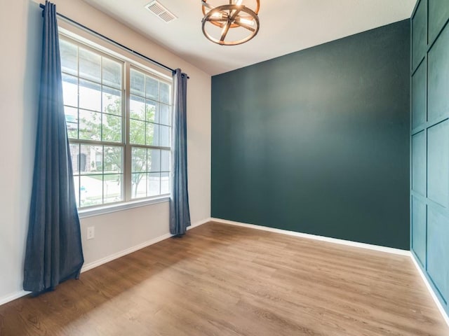 3305 Brentwood Cv, Forney, TX 75126 - spare room with light wood finished floors, a chandelier, and baseboards