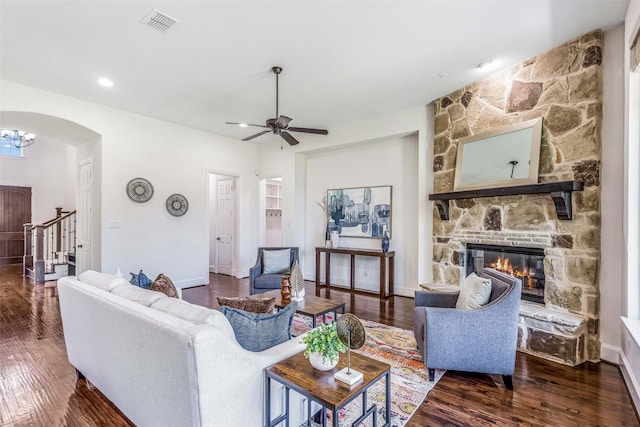 901 Clear Water Dr, Allen, TX 75013 - living area with a fireplace, wood finished floors, arched walkways, ceiling fan, and baseboards