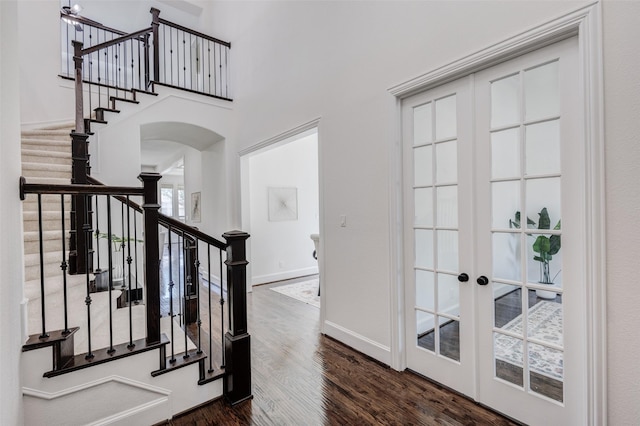 901 Clear Water Dr, Allen, TX 75013 - entryway featuring arched walkways, stairs, dark wood-style flooring, french doors, and baseboards