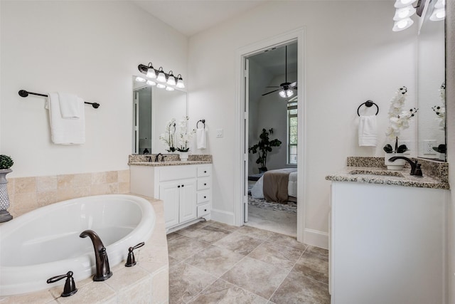 901 Clear Water Dr, Allen, TX 75013 - ensuite bathroom with a garden tub, two vanities, ceiling fan, and baseboards