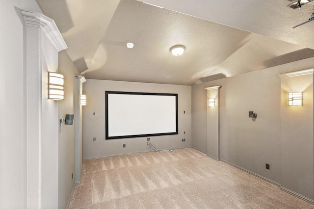 901 Clear Water Dr, Allen, TX 75013 - home theater room with light colored carpet, vaulted ceiling, baseboards, and a textured ceiling