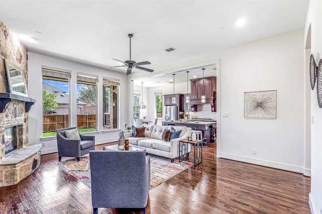 901 Clear Water Dr, Allen, TX 75013 - living area with ceiling fan, wood finished floors, a stone fireplace, baseboards, and recessed lighting