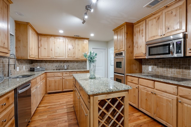 5820 Forest Ln, Dallas, TX 75230 - kitchen featuring stainless steel appliances, light wood finished floors, light brown cabinets, a sink, and recessed lighting