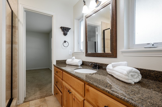 5820 Forest Ln, Dallas, TX 75230 - bathroom featuring vanity, tile patterned floors, and a shower