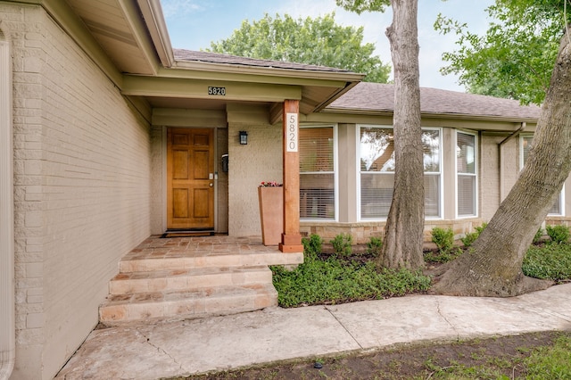 5820 Forest Ln, Dallas, TX 75230 - view of exterior entry featuring a shingled roof