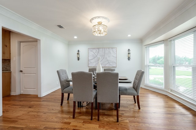 5820 Forest Ln, Dallas, TX 75230 - dining room with a chandelier, light wood finished floors, crown molding, baseboards, and recessed lighting