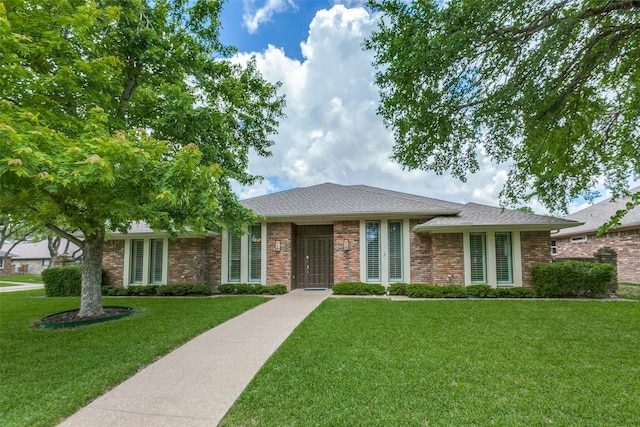 10101 Apple Creek Dr, Dallas, TX 75243 - ranch-style home featuring a front yard, a shingled roof, and brick siding