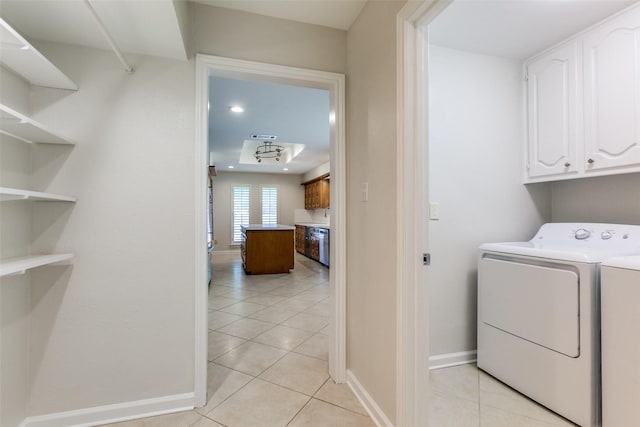 10101 Apple Creek Dr, Dallas, TX 75243 - washroom with cabinet space, washing machine and dryer, light tile patterned floors, and baseboards