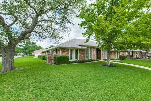 10101 Apple Creek Dr, Dallas, TX 75243 - single story home featuring a front lawn, brick siding, and roof with shingles