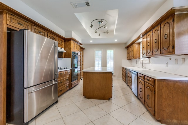 10101 Apple Creek Dr, Dallas, TX 75243 - kitchen with black appliances, a kitchen island, a sink, light tile patterned flooring, and light countertops