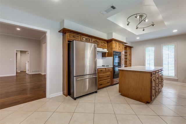 10101 Apple Creek Dr, Dallas, TX 75243 - kitchen with freestanding refrigerator, light countertops, baseboards, a raised ceiling, and a kitchen island