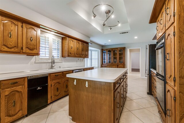 10101 Apple Creek Dr, Dallas, TX 75243 - kitchen with a sink, a center island, brown cabinets, a raised ceiling, and recessed lighting
